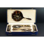 George V Harrods silver and tortoiseshell five piece dressing table set, with inlaid floral and