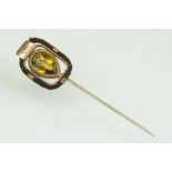 19th century citrine and hair rose metal stick pin, the pear shaped mixed cut citrine measuring