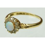 Late 19th century opal and diamond 18ct yellow gold cluster ring, the round cabochon precious