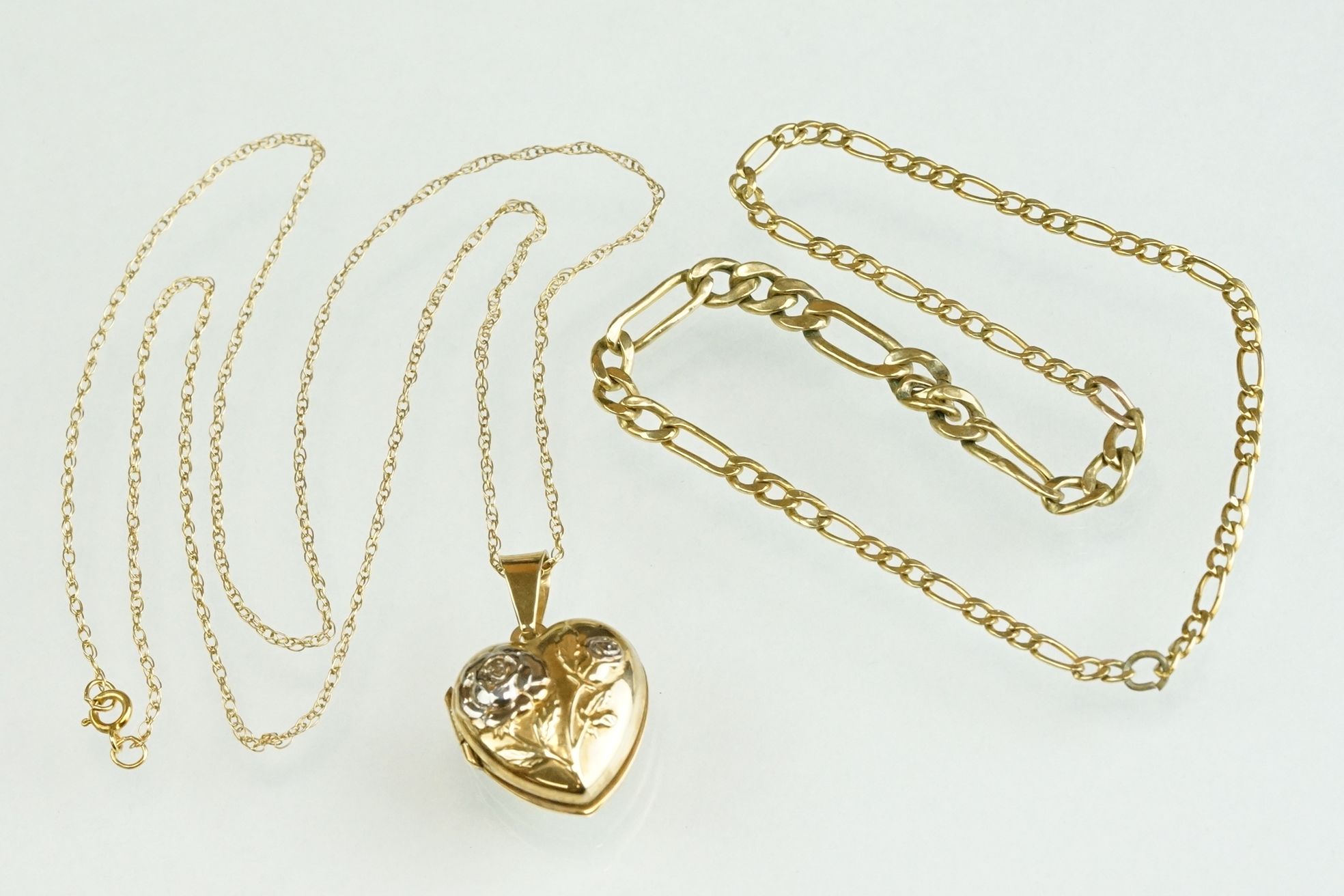 9ct yellow and white gold set gold heart shaped locket pendant, the lock with rose decoration in