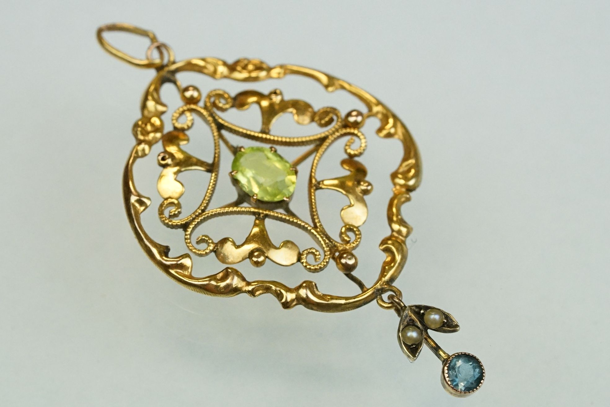 Edwardian peridot, zircon and seed pearl 9ct yellow gold pendant, the oval mixed cut peridot to