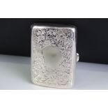 Early 20th Century silver cigarette case of curved form, with engraved scrolling foliate