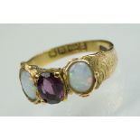 Mid Victorian amethyst and opal 15ct yellow gold three stone ring, the centre oval mixed cut