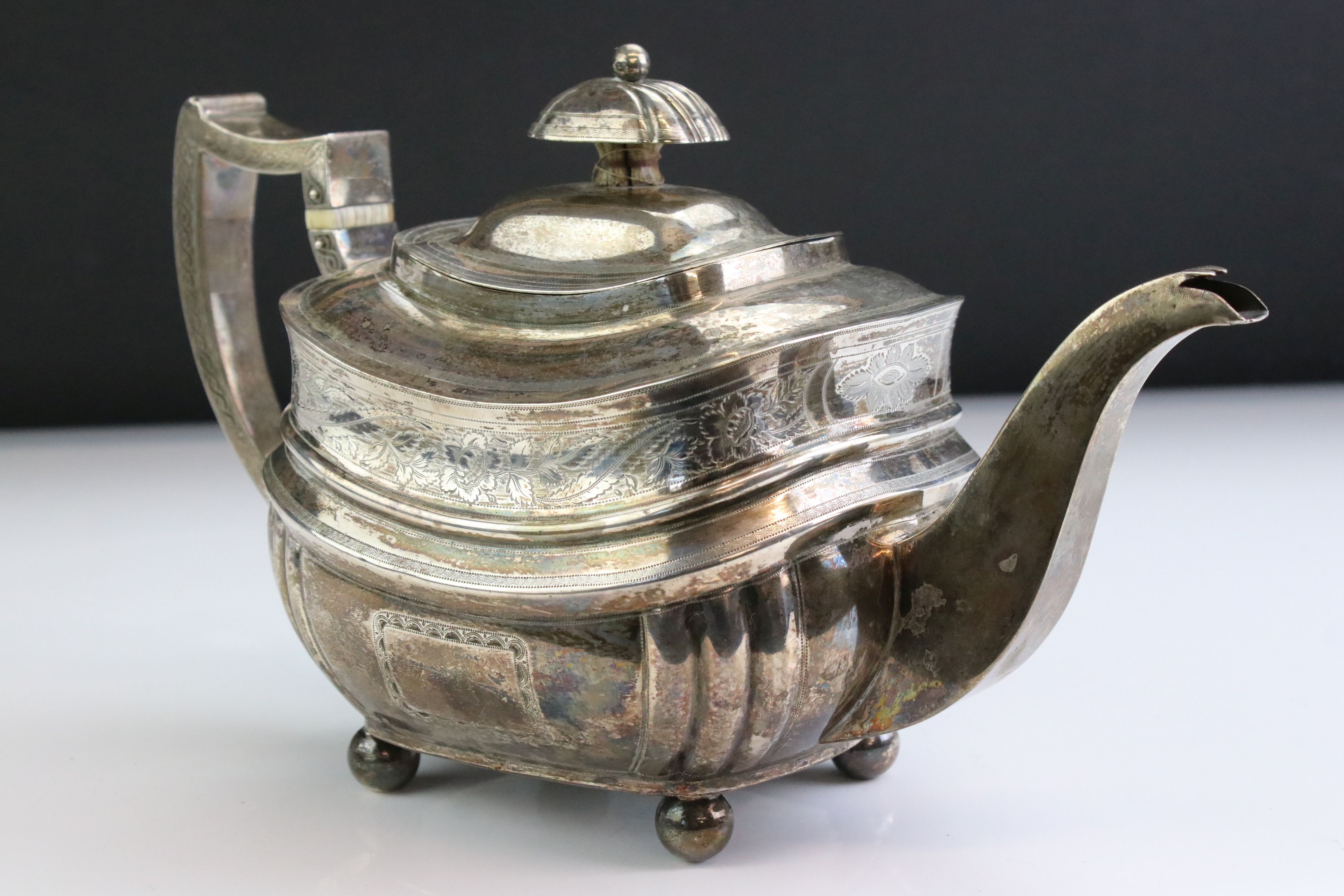 George III silver teapot raised on four ball feet, engraved floral and foliate decoration to the - Image 2 of 6