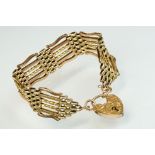 Late Victorian/ Edwardian 9ct gold gate link bracelet with padlock clasp, the bracelet with plain