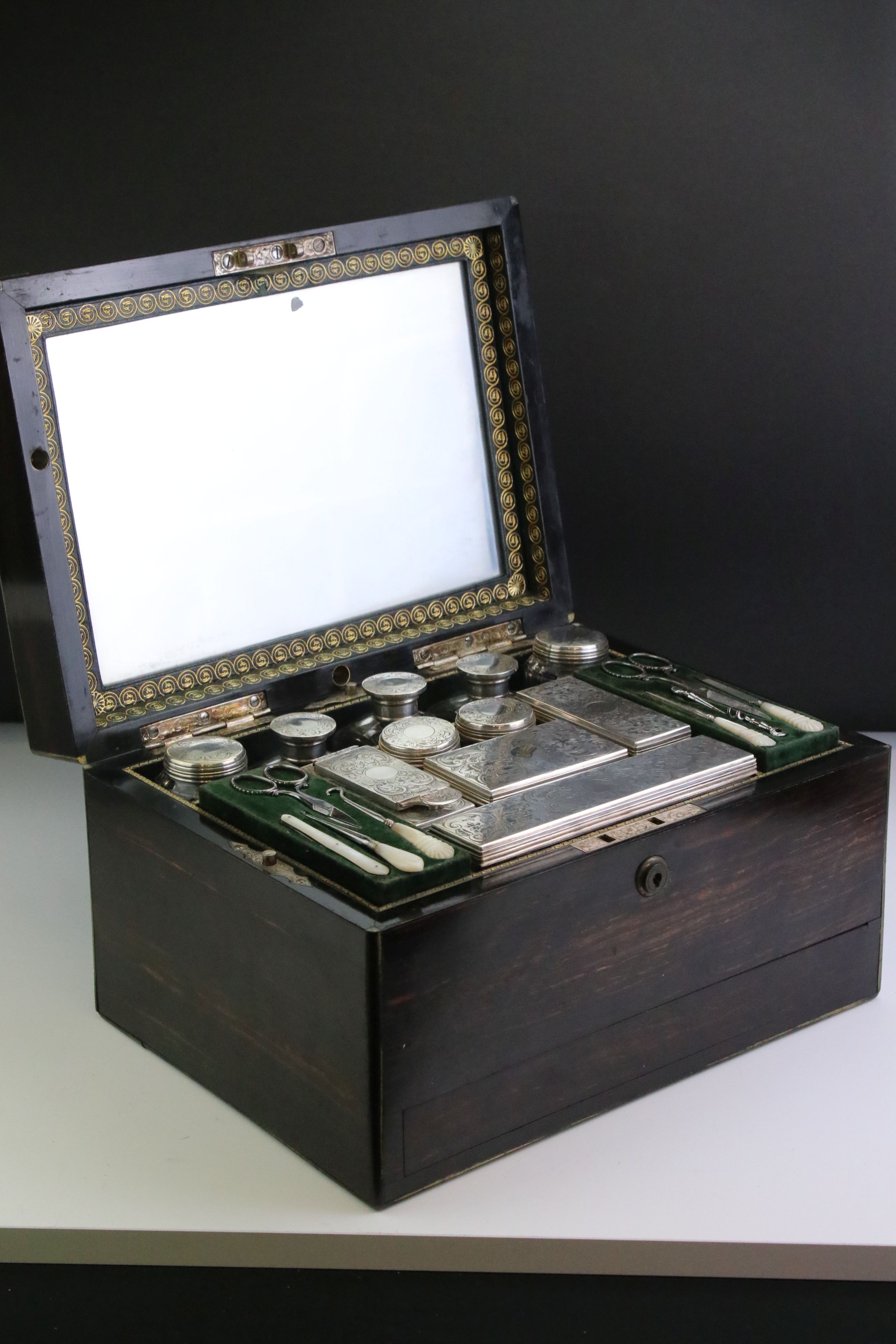 Mid 19th century coromandel travelling dressing box, containing silver topped dressing table jars,