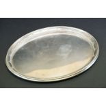 Sterling silver oval serving tray with moulded rim, embossed beading & banding decoration to border,