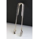 Pair of George IV silver fiddle pattern sugar tongs, shell bowls, initialled cartouche, makers