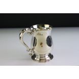 Silver footed mug, scroll handle with applied acanthus leaf, moulded stepped foot, engraved