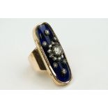 Diamond enamelled unmarked gold and silver set ring, the oval blue enamelled head set with central