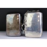 Two George V silver cigarette cases of plain polished curved rectangular form, with gilt