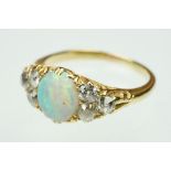 Opal and diamond unmarked yellow gold ring, the central oval cabochon cut precious white opal