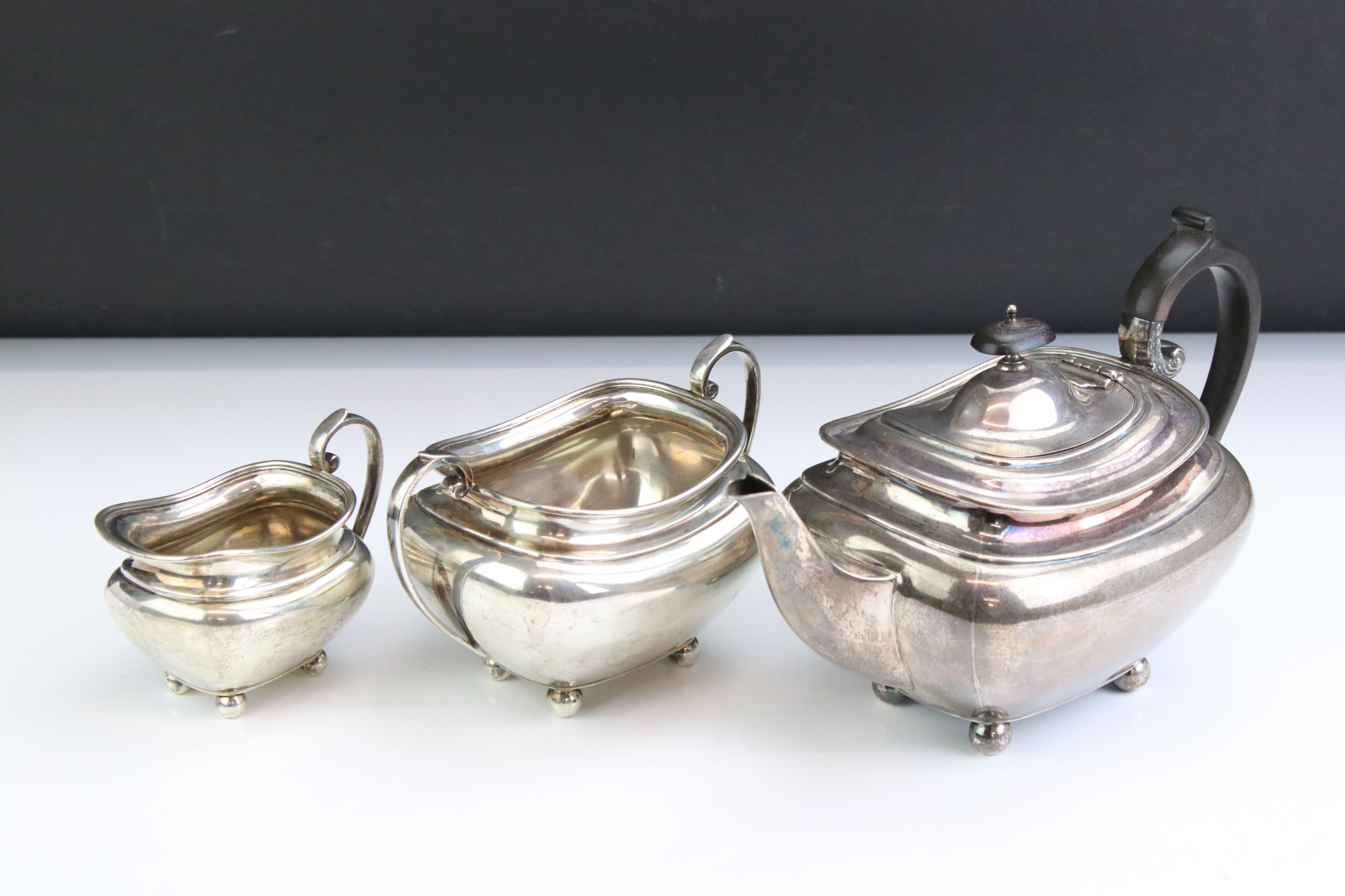 George V silver three piece tea service, comprising teapot, milk jug and a twin-handled sugar