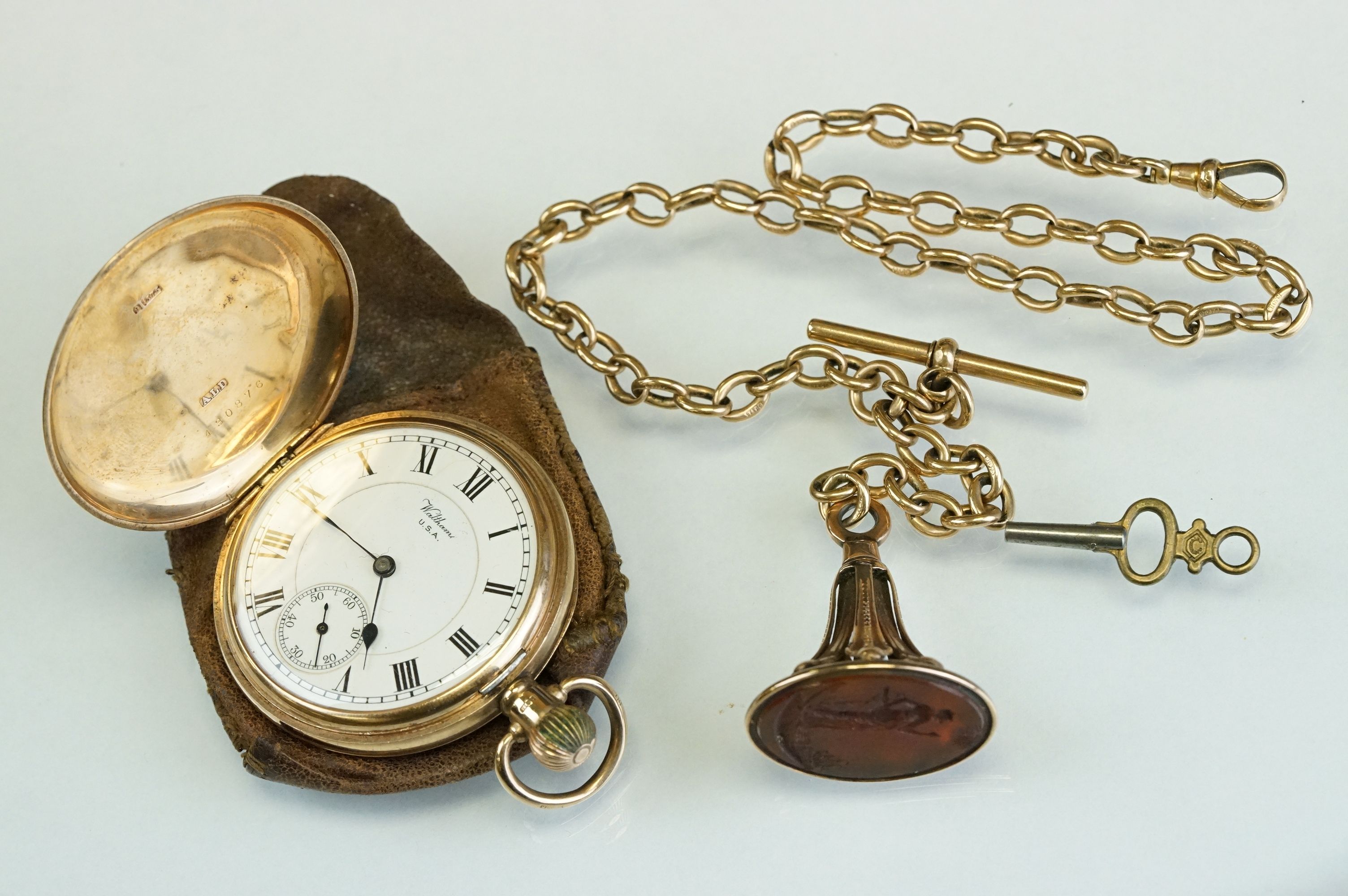 Waltham 9ct yellow gold full hunter top wind pocket watch, with black roman numerals on a white