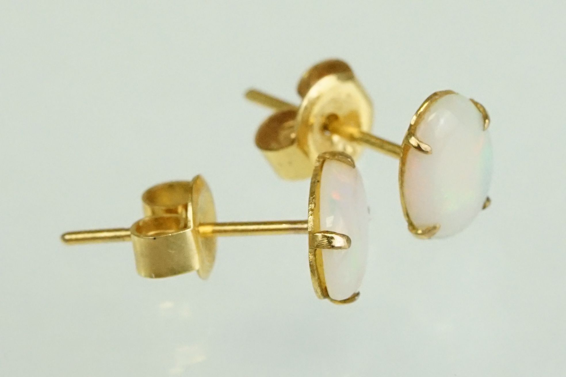 Pair of precious white opal 9ct yellow gold stud earrings, the opals displaying yellow, green, - Image 13 of 17