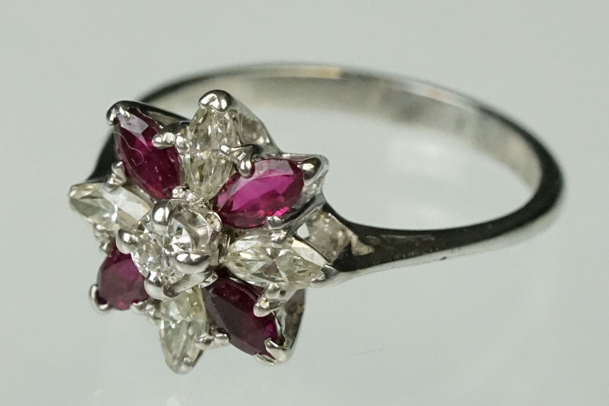 Ruby and diamond 18ct white gold flower head ring, central small round brilliant cut diamond