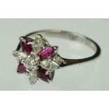 Ruby and diamond 18ct white gold flower head ring, central small round brilliant cut diamond