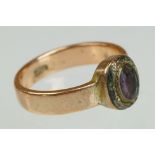 19th century almandine garnet 9ct rose gold ring, the oval mixed cut garnet measuring approx 5.5mm x
