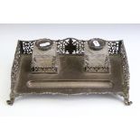 Edwardian silver standish with two cut glass silver topped ink wells, the stand with pierced foliate