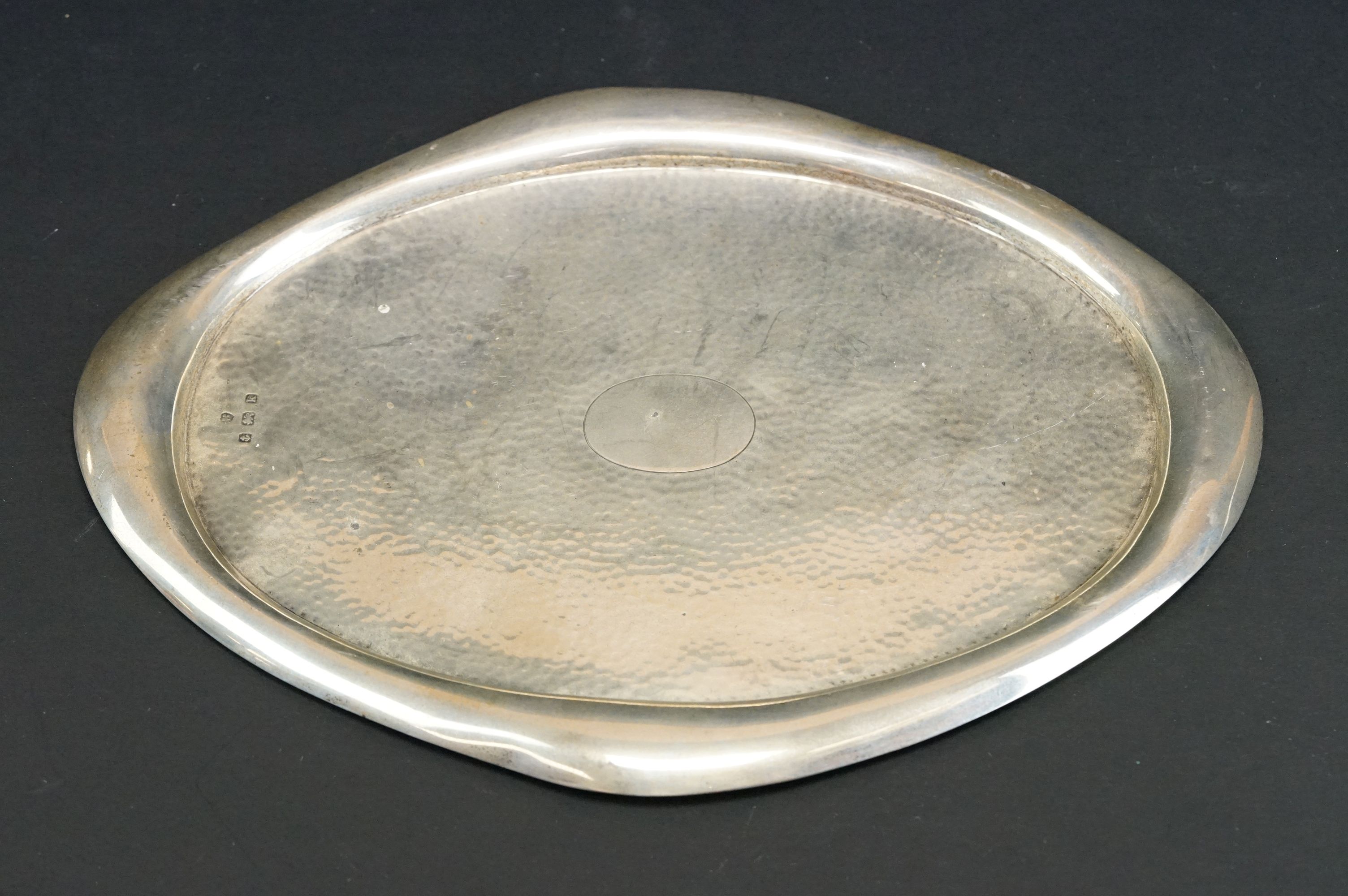 Silver oval planished tray, vacant cartouche to centre, plain polished border, makers Williams