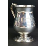 Silver footed mug, scroll handle with acanthus leaf, baluster form, moulded stepped foot, engraved