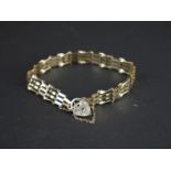 A fully hallmarked 9ct gold gate bracelet with traditional heart lock clasp.