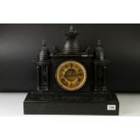 19th Century slate mantle clock with Roman numerals on a brass dial, flanked by two four-column