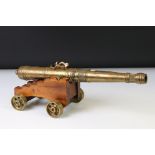 Maltese brass and mahogany fireside cannon model, with applied Maltese cross decoration, raised on