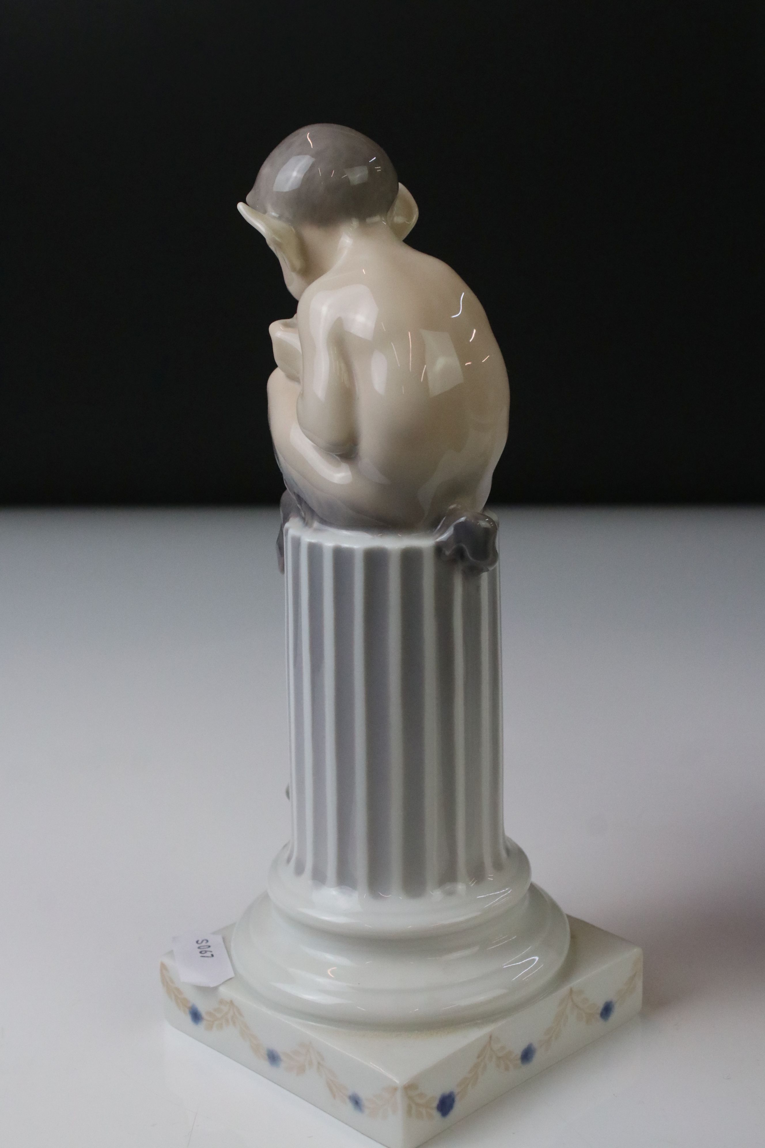 Two Royal Copenhagen porcelain figures to include a faun playing a mouth organ seated on fluted - Image 4 of 9