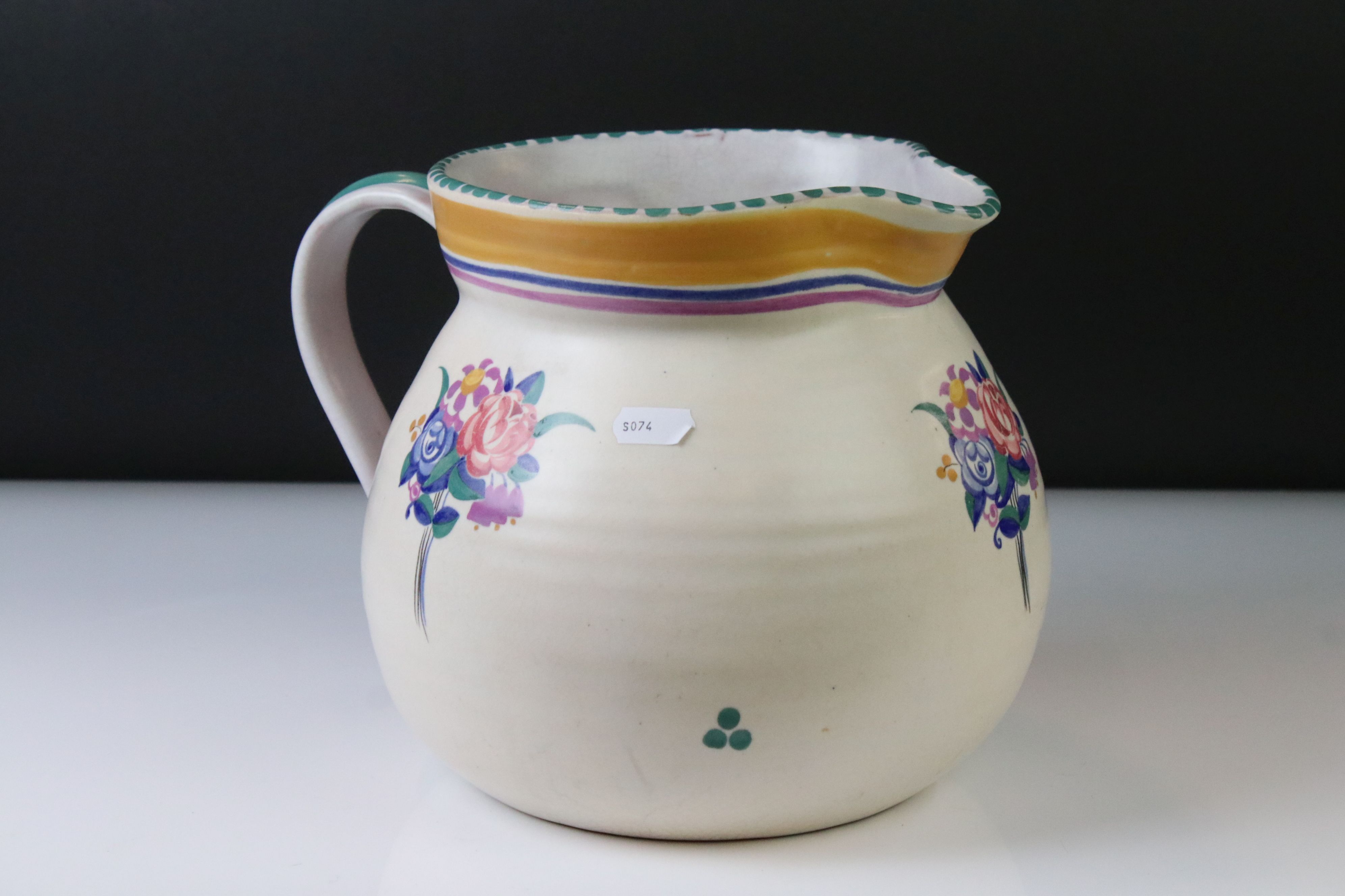 Poole Pottery Carter Stabler Adams Ltd jug with polychrome floral motifs and banding to the upper