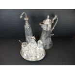 A silver plate and cut glass condiment set together with a silver plate and cut glass claret jug.