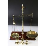 Set of brass shop balance scales by W & T Avery Ltd, Birmingham, standing on a rectangular