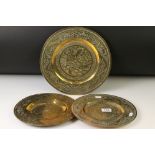 Set of three Chinese brass plates with engraved dragon and Greek key-style decoration, comprising