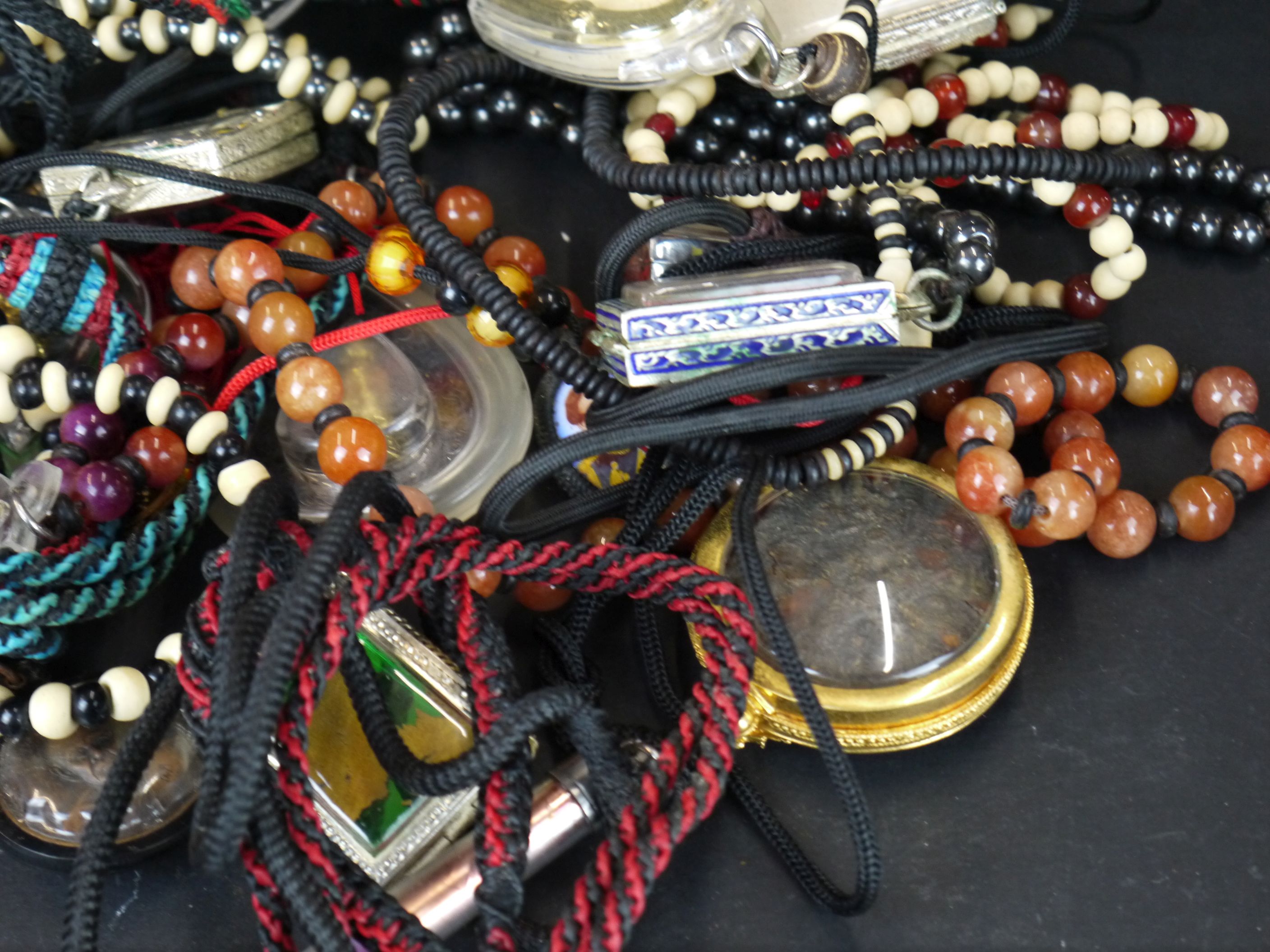 A large collection of oriental strung amulets . - Image 5 of 6