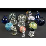 12 Glass paperweights to include a Hadeland apple-shaped example, signed, 9.5cm high, a Hadeland