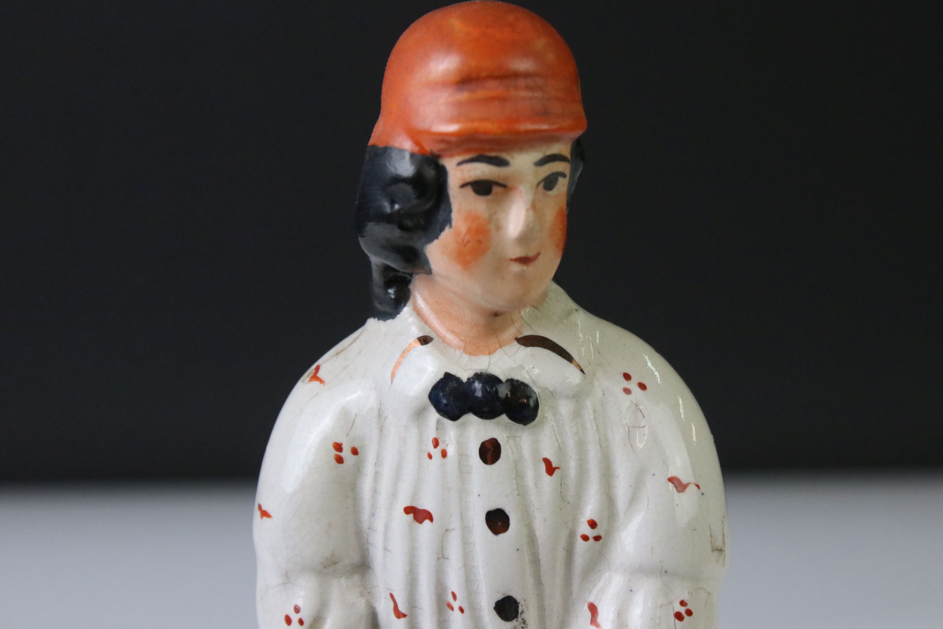 19th Century Staffordshire figure of a batsman wearing an orange cap, a cream spotted shirt, holding - Image 2 of 5