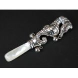 Large silver babies rattle in the form of a seahorse with ruby eyes