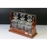 Early 20th century Oak Three Bottle Tantalus with Silver Plated Mounts marked PB & S, three matching