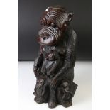 African carved hardwood stylised figure of a family group of monkeys, comprising the mother with a