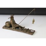 Chinese bronze figure of a fisherman on a bamboo raft, with rod in hand, measures approx 28cm long