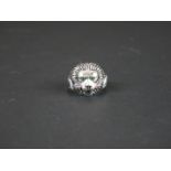 Silver lion mask ring set with emerald eyes