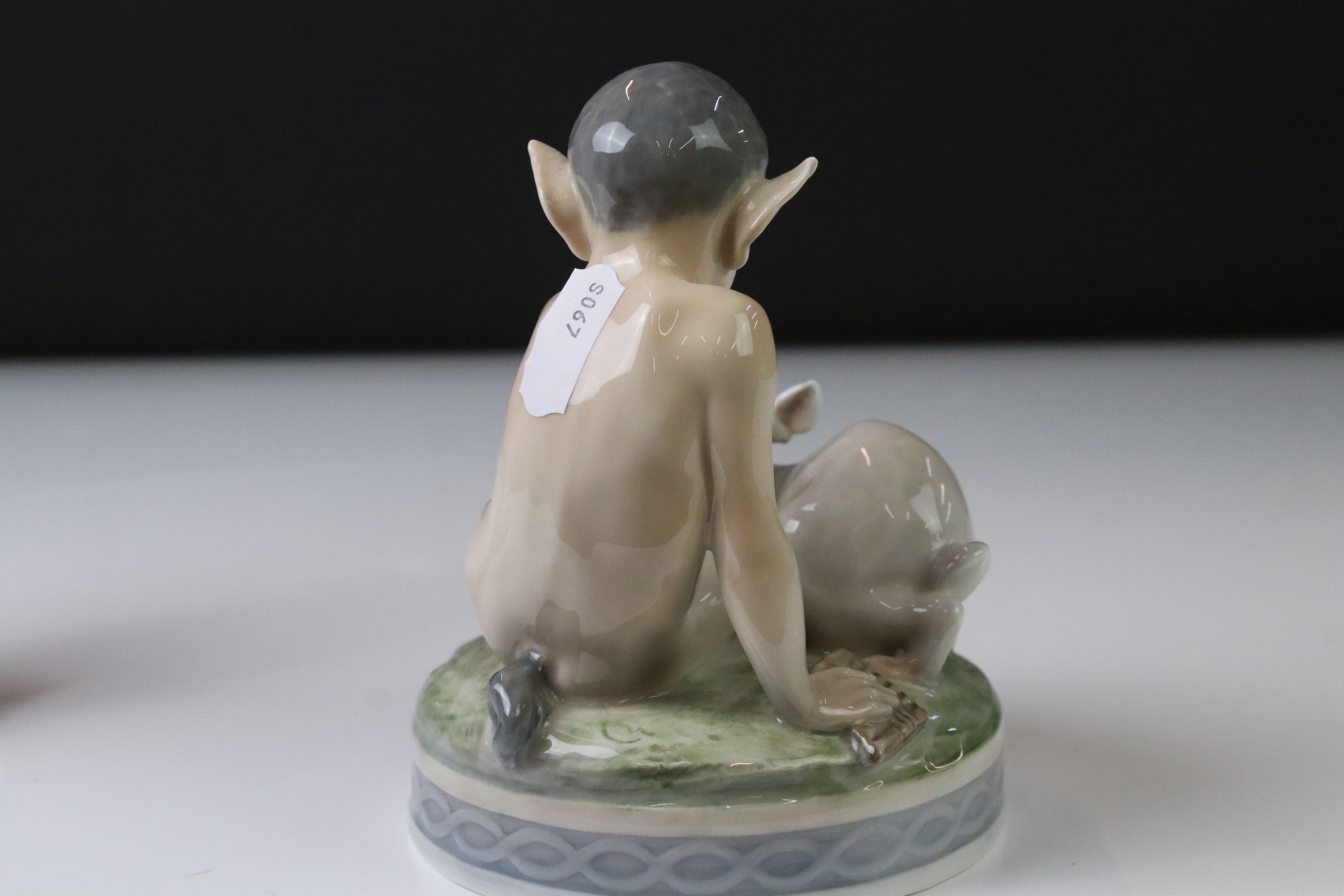 Two Royal Copenhagen porcelain figures to include a faun playing a mouth organ seated on fluted - Image 8 of 9
