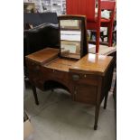 George III Mahogany bow front enclosed Dressing Table, the central hinged lid enclosing a ratchet