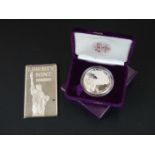 A Liberty Mint 5 Troy Oz fine silver ingot together with a 1 Oz proof silver bullion American