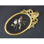 19th century Italian pietra dura oval panel depicting a bird in a flowering branch, approx. 9.5 x