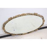 Oval Bevelled Edge Mirror with a scrolling gilt frame, 67cm x 39cm