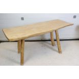 Rustic Oak and Elm Table, the shaped top cut from one solid piece, raised on four turned supports,
