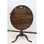 George III Oak Circular Tilt Top Table raised on a column support and three splayed legs, 72cm