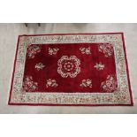 Chinese Red Ground Rug with floral pattern within a cream border, 288cm x 184cm