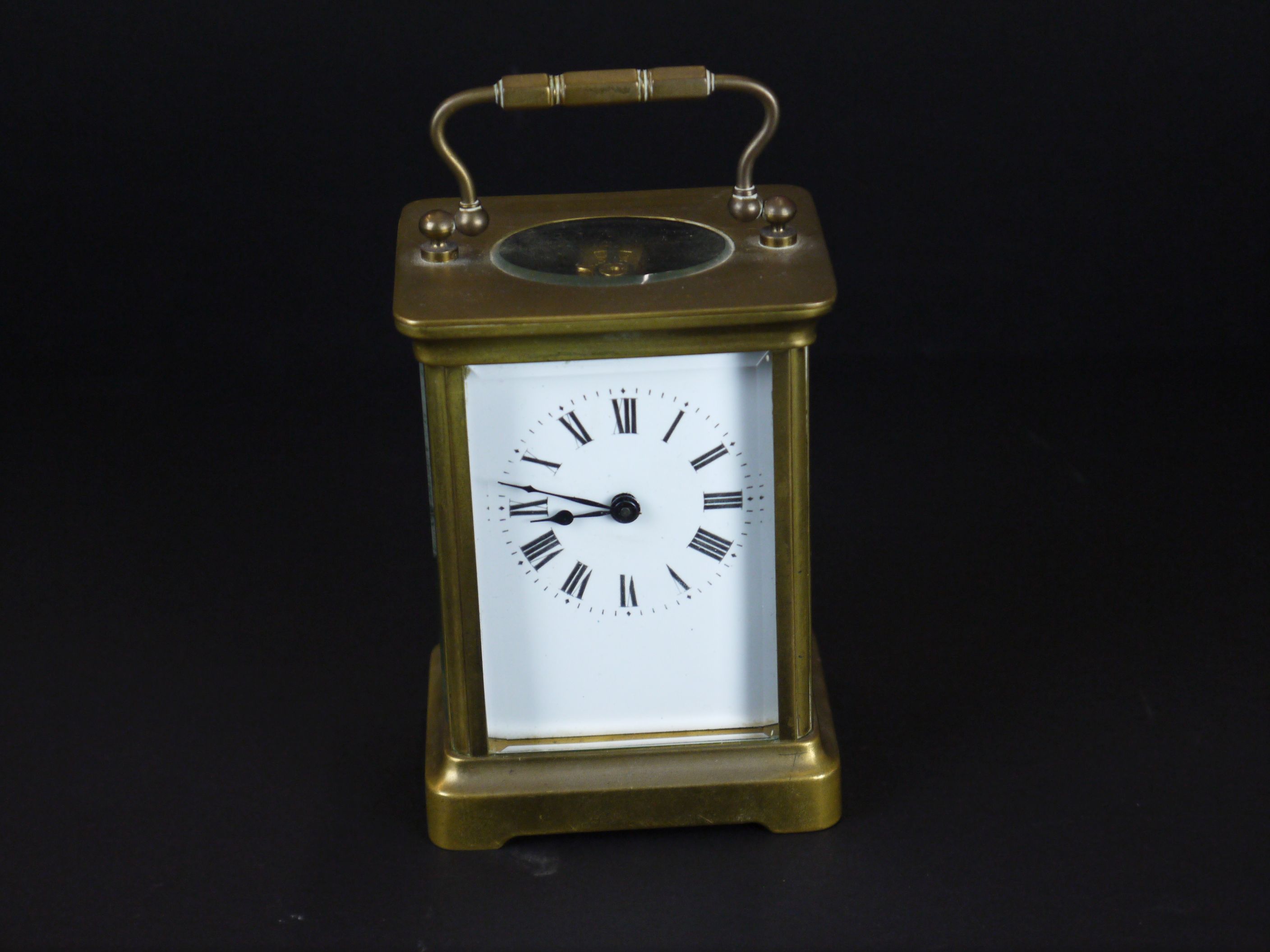 An early 20th century brass cased carriage clock with bevelled glass panels and white enamel dial. - Image 2 of 4